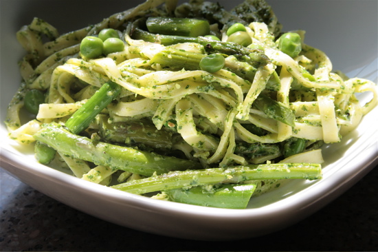 Mouth-watering vegan pesto pasta delicacy with spring vegetables