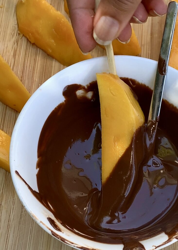 Chocolate coating mangoes 